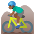 man mountain biking, medium-dark skin tone